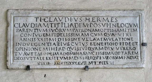 A Roman marble memorial inscription for Claudia Ilias. The last line reads VIXIT ANNIS XXXXVII M I DIEB II.